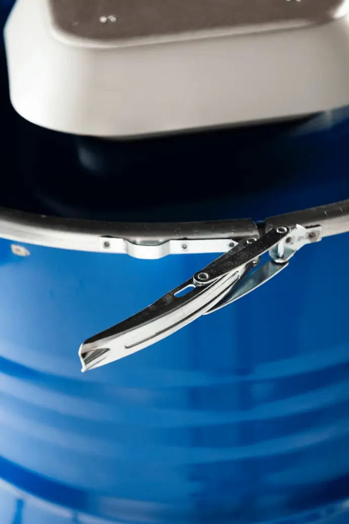 alt="Close-up of a blue Barrel with a metal locking mechanism and top panel, showcasing durable design"