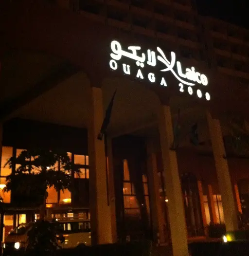 alt="Night view of Laico Ouaga 2000 hotel in Burkina Faso with illuminated signage"