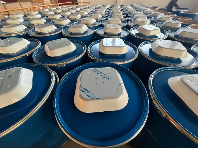 title="Barrel solar energy systems production in Italy" alt="Rows of blue Barrel solar energy systems in a production facility in Italy"